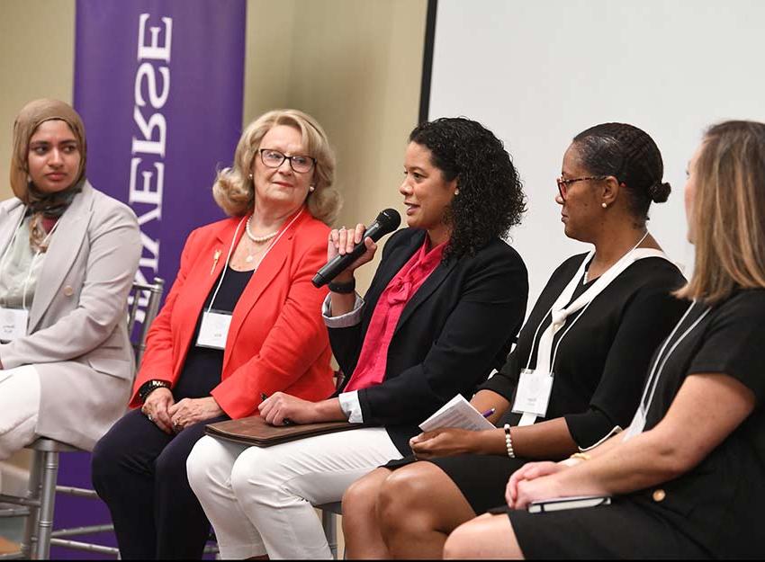 A group of panelists speak to Converse University guests at the leadership conference.