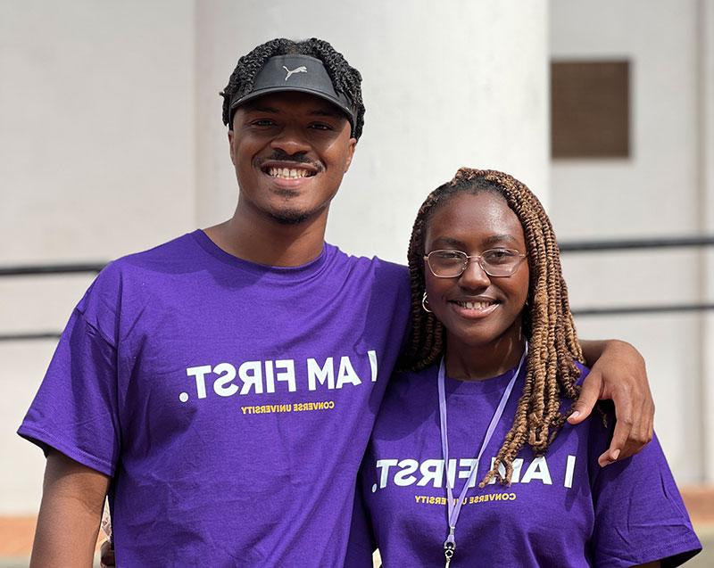 The Medley siblings smile while wearing Converse University 'I am first' t-shirts.